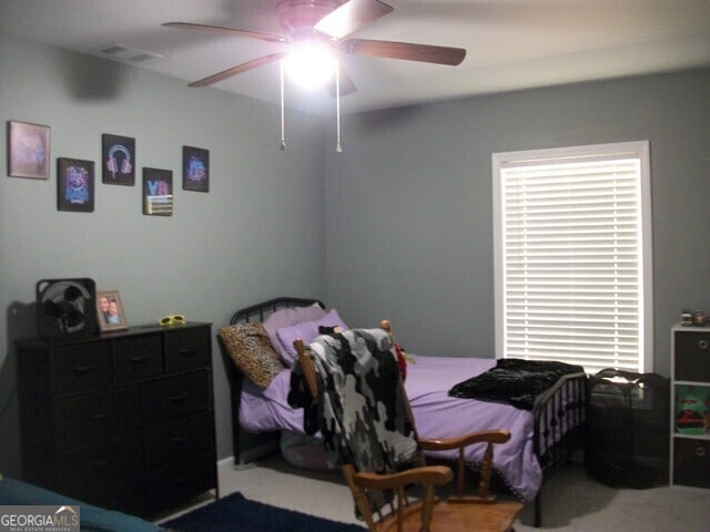 carpeted bedroom featuring ceiling fan