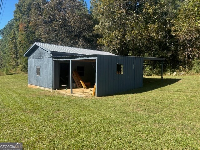 view of outbuilding featuring a yard