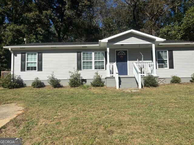 view of front of home featuring covered porch and a front lawn