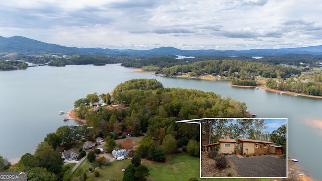 birds eye view of property with a water and mountain view