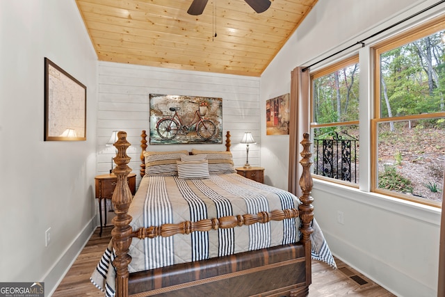 bedroom with hardwood / wood-style flooring, wood ceiling, ceiling fan, and vaulted ceiling