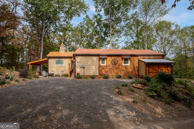 rear view of property with a carport