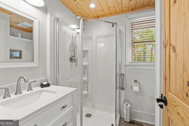 bathroom with wooden ceiling, hardwood / wood-style flooring, a shower with shower door, and vanity