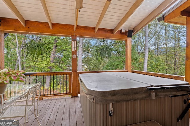 wooden deck featuring a hot tub