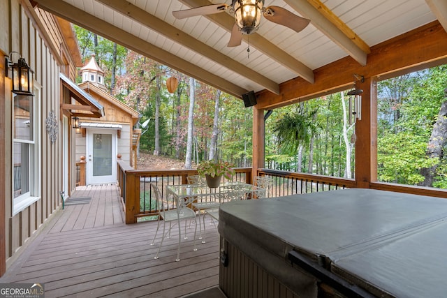 wooden terrace featuring ceiling fan and a hot tub