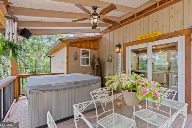 deck featuring ceiling fan and a hot tub