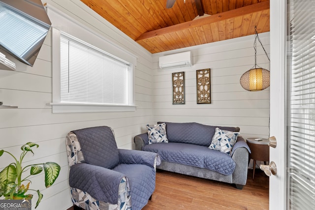 living area featuring wooden ceiling, light hardwood / wood-style floors, wood walls, a wall mounted AC, and beam ceiling