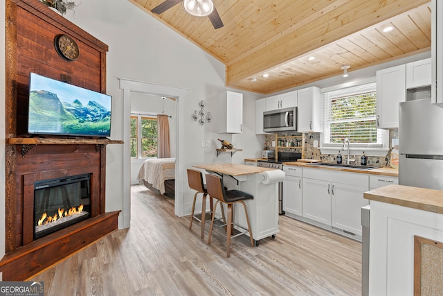 kitchen with white cabinetry, appliances with stainless steel finishes, wooden ceiling, and wood counters