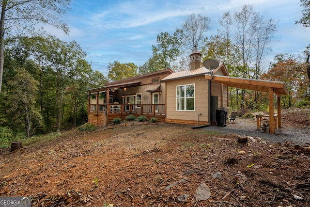 rear view of house featuring a deck