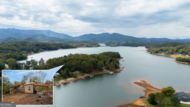 aerial view featuring a water and mountain view