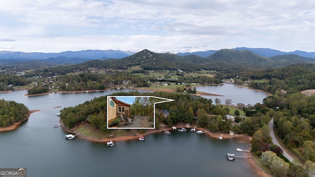 drone / aerial view featuring a water and mountain view