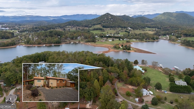 drone / aerial view featuring a water and mountain view