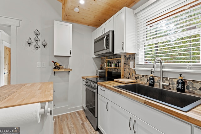 kitchen featuring white cabinetry, appliances with stainless steel finishes, and plenty of natural light