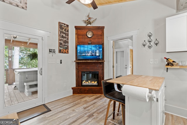 dining room with lofted ceiling with beams, light hardwood / wood-style flooring, ceiling fan, and wood ceiling