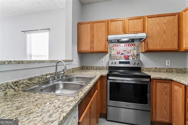 kitchen featuring stainless steel electric stove, light stone counters, a textured ceiling, and sink