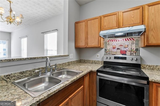 kitchen with sink, a notable chandelier, stainless steel range with electric cooktop, light stone counters, and a textured ceiling