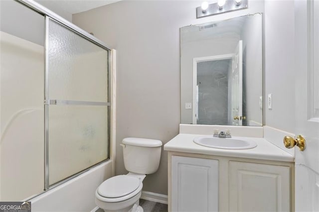 full bathroom featuring toilet, bath / shower combo with glass door, and vanity