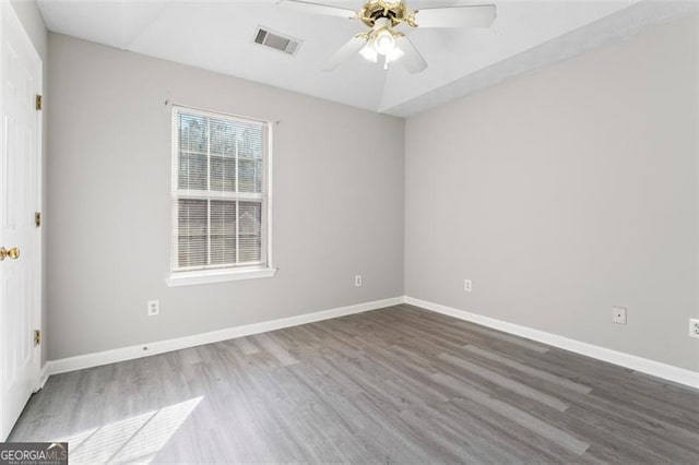 spare room featuring wood-type flooring and ceiling fan