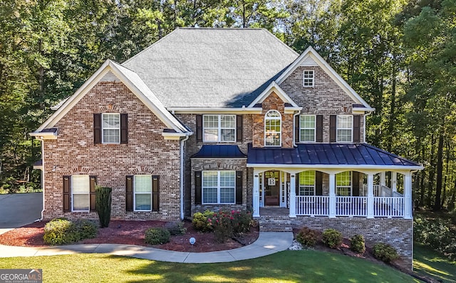 view of front of house featuring a front yard and a porch