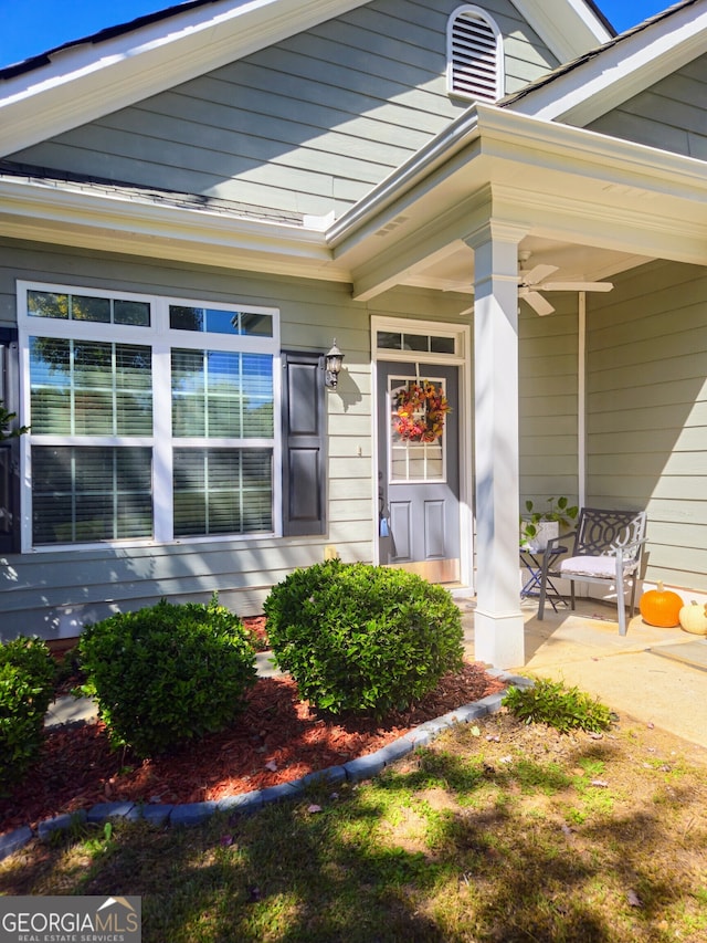 view of exterior entry with ceiling fan