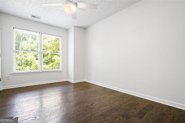 spare room featuring a textured ceiling, ceiling fan, and dark hardwood / wood-style flooring