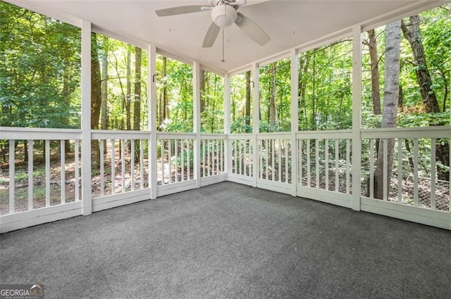 unfurnished sunroom with ceiling fan