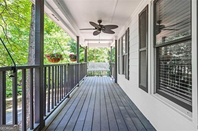 deck with covered porch and ceiling fan