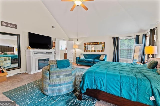 carpeted bedroom featuring ceiling fan and high vaulted ceiling