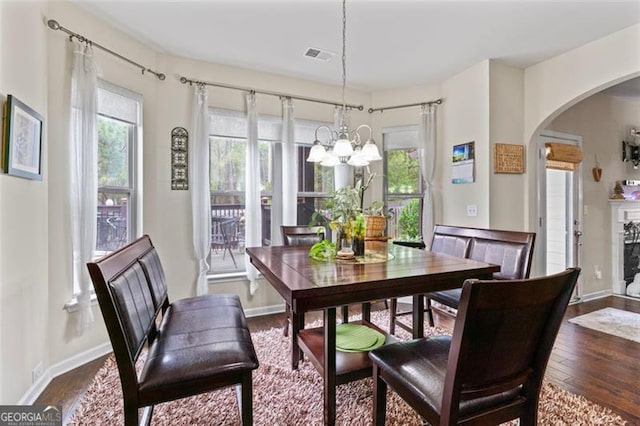 dining room featuring dark wood-type flooring and a notable chandelier