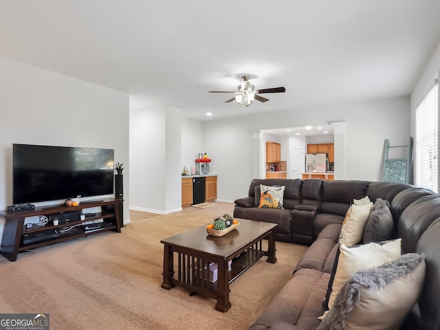 carpeted living room with ceiling fan