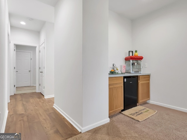 bar featuring refrigerator and sink