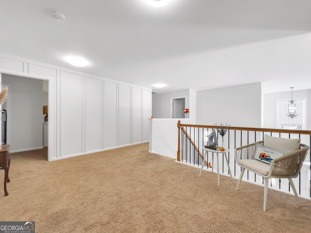 interior space featuring light colored carpet and a chandelier