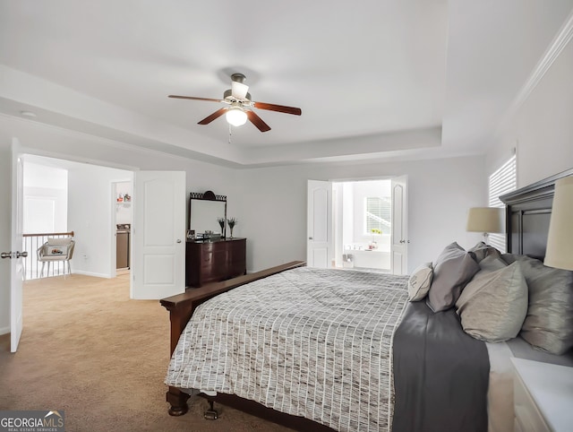 bedroom with ceiling fan, light carpet, a tray ceiling, and multiple windows