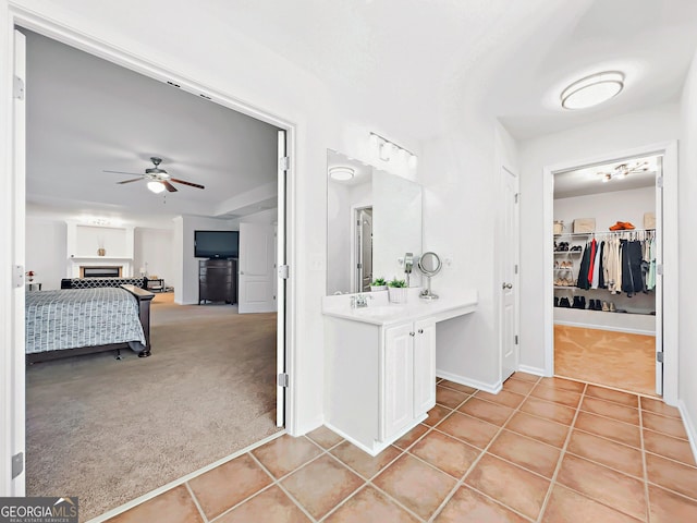 bathroom with tile patterned flooring, ceiling fan, and vanity