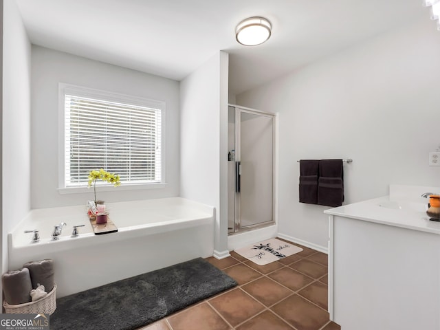 bathroom with vanity, tile patterned flooring, and plus walk in shower