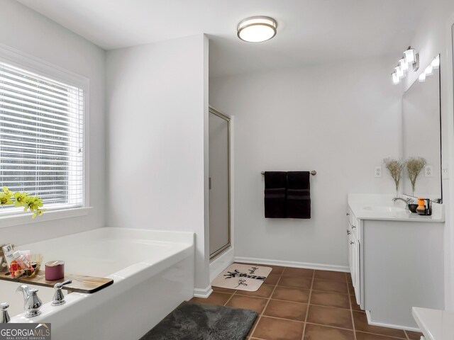 bathroom featuring plenty of natural light, tile patterned floors, vanity, and separate shower and tub