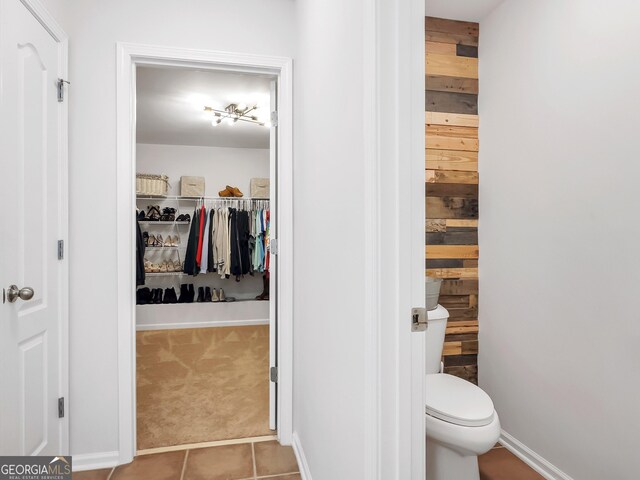 bathroom with toilet and tile patterned flooring