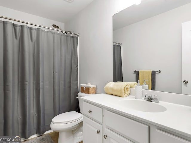 bathroom featuring toilet and vanity