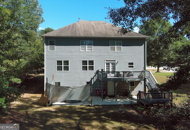 rear view of house with a patio area, a deck, and french doors