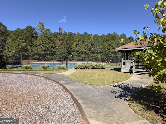 surrounding community featuring a lawn, a gazebo, and tennis court