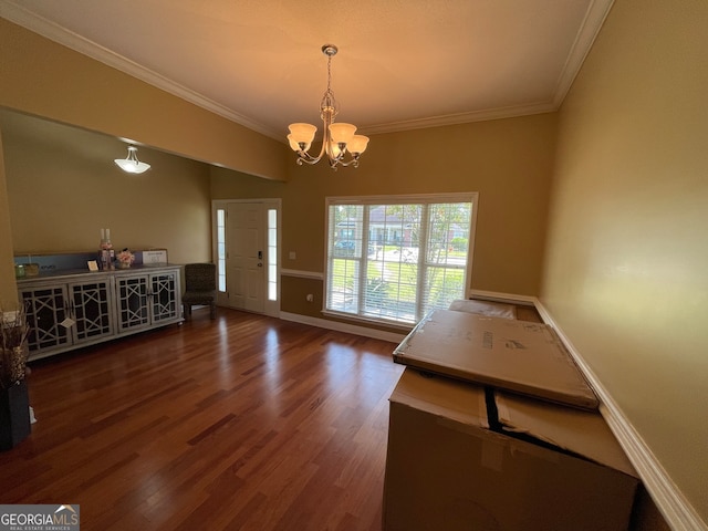 interior space with ornamental molding, an inviting chandelier, and dark hardwood / wood-style floors