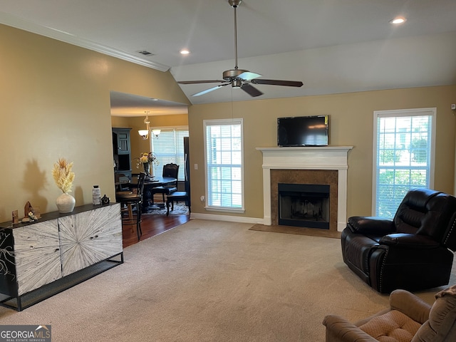 living room with carpet, vaulted ceiling, ceiling fan with notable chandelier, and plenty of natural light