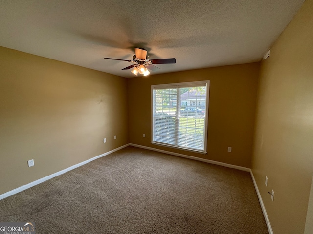 carpeted spare room with a textured ceiling and ceiling fan