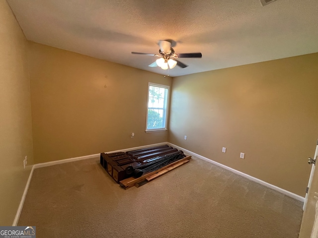 unfurnished bedroom featuring ceiling fan, carpet flooring, and a textured ceiling