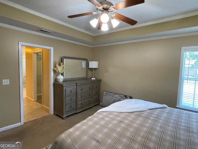 bedroom with ornamental molding, light colored carpet, and ceiling fan