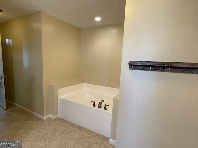 bathroom with a tub and tile patterned floors