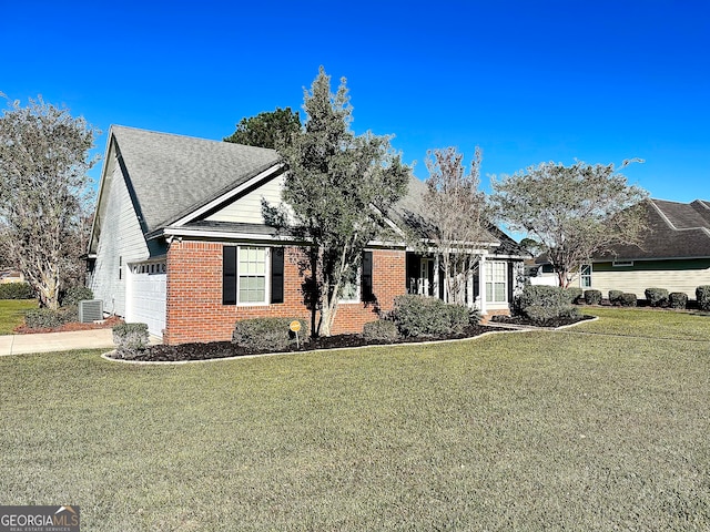 view of front facade with central air condition unit, a front yard, and a garage