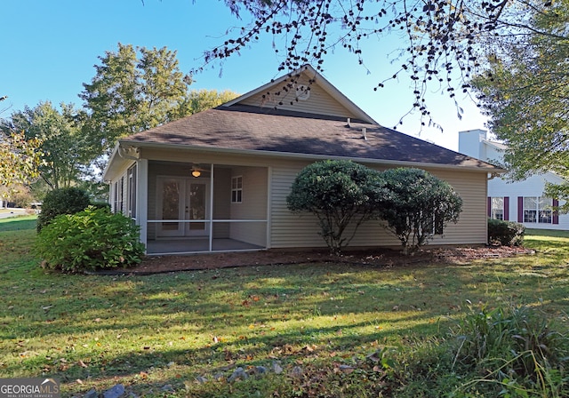 back of house with a patio and a lawn