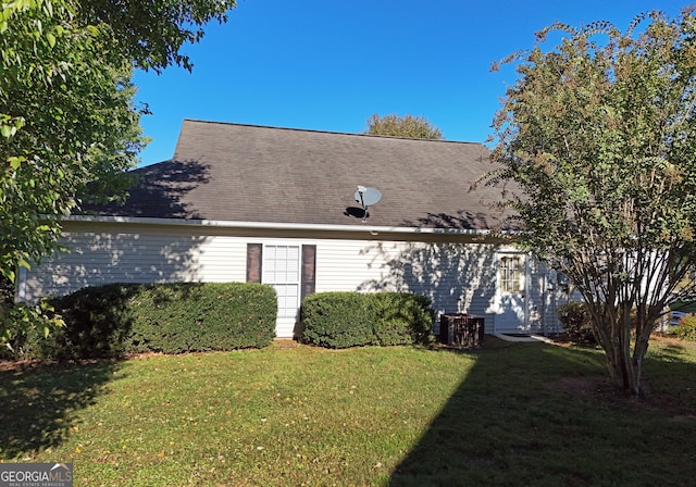 rear view of property with a lawn