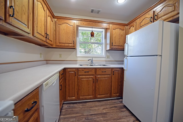 kitchen with dark hardwood / wood-style floors, sink, and white appliances